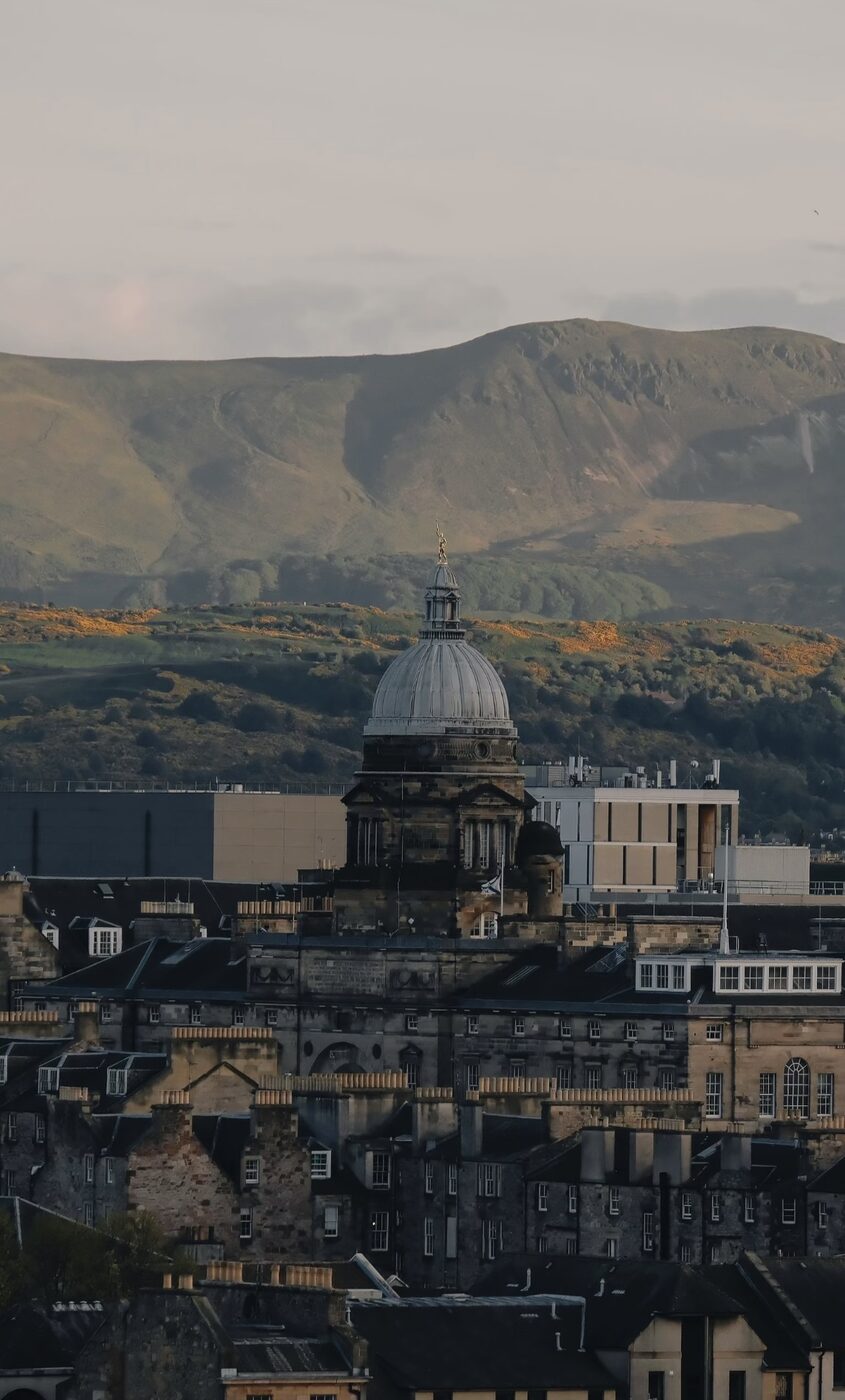 Edinburgh rooftops and a dome against dark hills