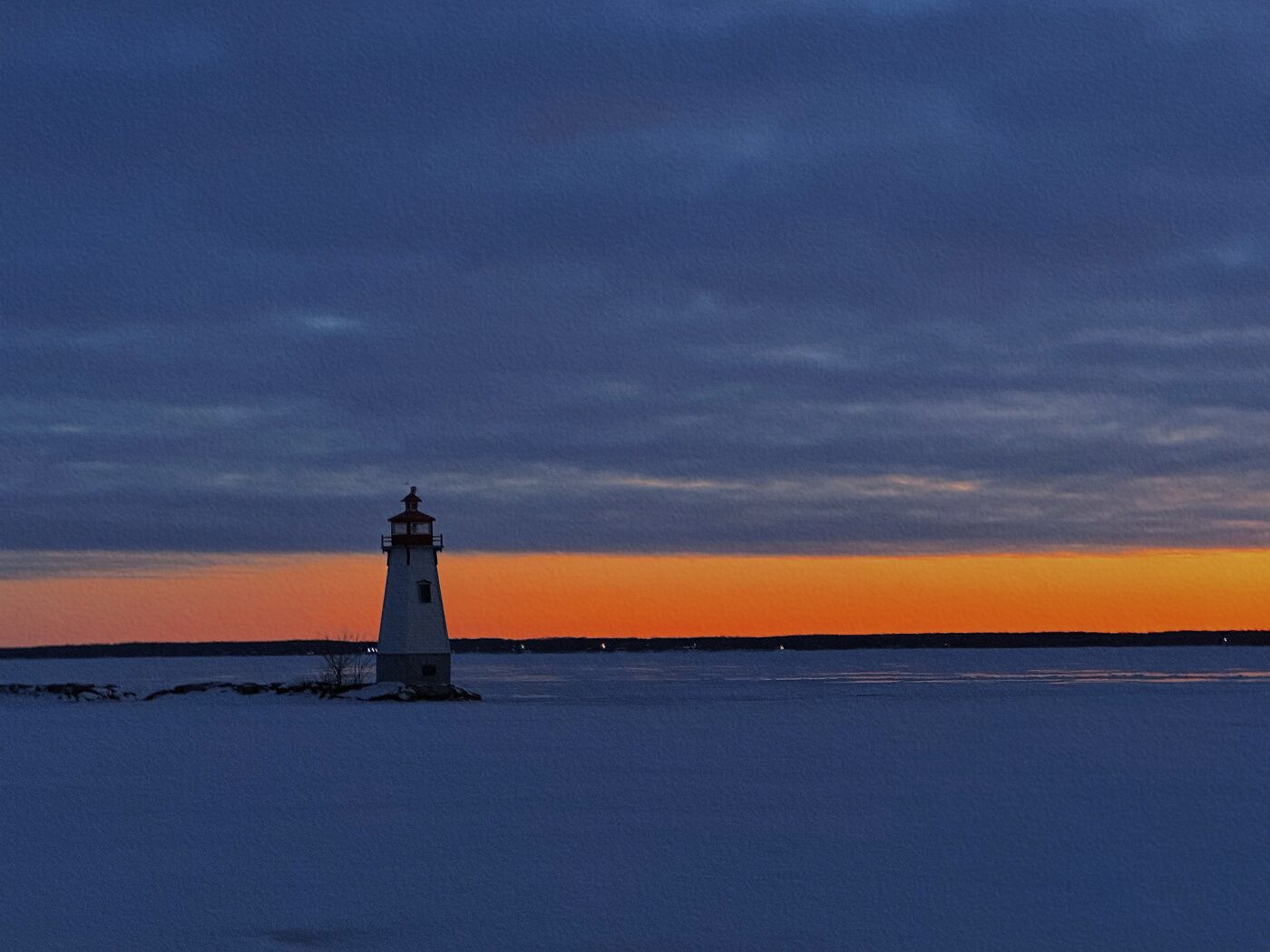A lighthouse on a frozen shore at dusk